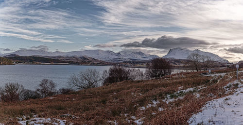 Scenic view of lake against sky during winter