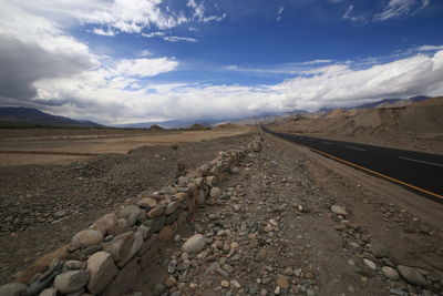 Surface level of railroad tracks on land against sky