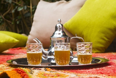 Midsection of wine glasses on table