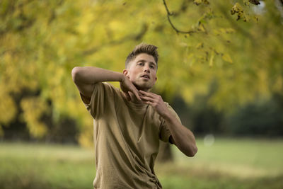 Close-up of young man dancing in forest