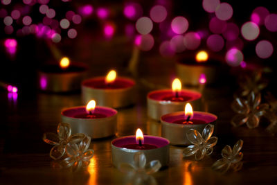 Close-up of lit tea light candles in temple