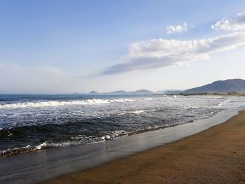 View of beach against cloudy sky
