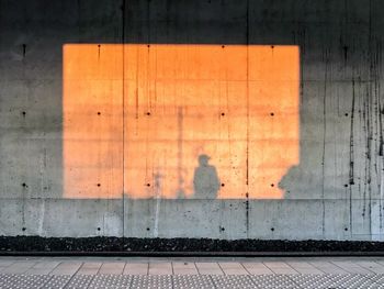 Shadow of man on railroad platform