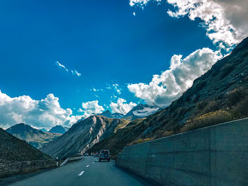 Road amidst mountains against sky