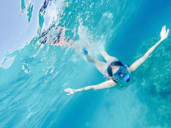 Portrait of young woman swimming in sea