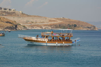 Boat sailing in sea against sky