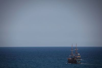 Scenic view of sea against clear sky and pirate ship