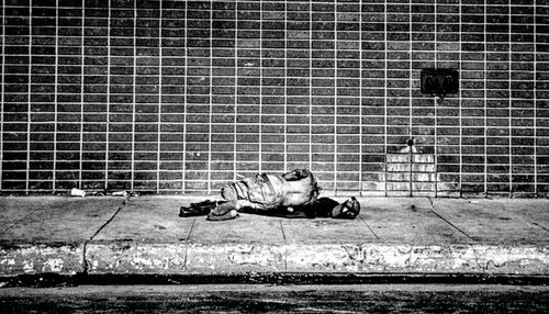 Full length of woman sitting on bench