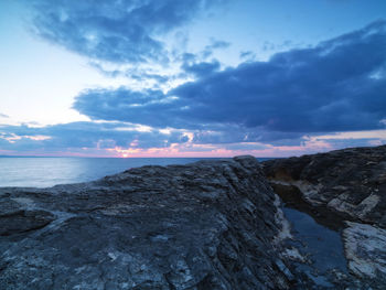 Scenic view of calm sea against cloudy sky