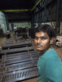 Portrait of man working on metal