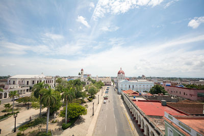 High angle view of buildings against cloudy sky