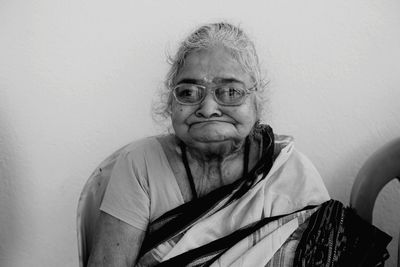 Portrait of smiling woman against wall