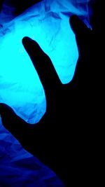 Close-up of silhouette person swimming in sea