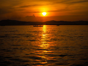 Scenic view of sea against romantic sky at sunset