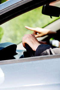 Close-up of human hand in car
