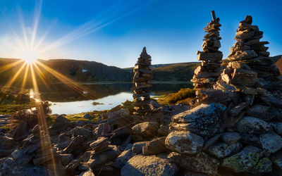 Scenic view of rocks against bright sun