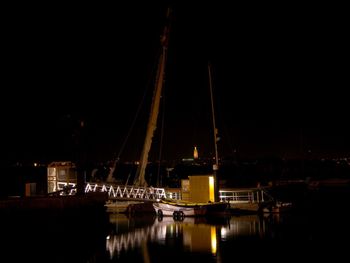 Sailboats in marina at night