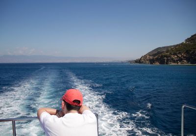 Young woman in sea against clear sky