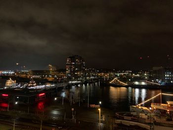 High angle view of illuminated cityscape against sky at night