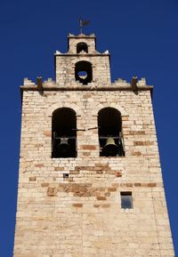 Low angle view of building against clear blue sky