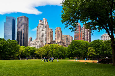 People in park with city in background