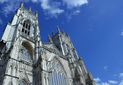 Low angle view of york minster against blue sky