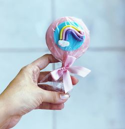 Close-up of hand holding multi colored flower