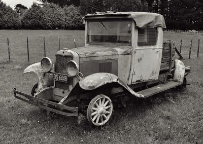 Abandoned car on field