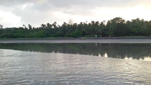 Scenic view of lake against cloudy sky