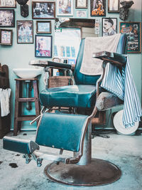 Empty chairs and table against wall