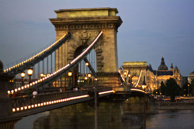 Bridge over river with city in background