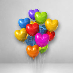 Close-up of multi colored balloons on white background