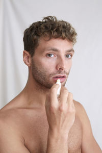 Close-up portrait of shirtless man