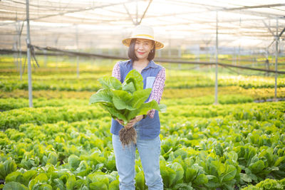 Portrait of smiling woman standing in field