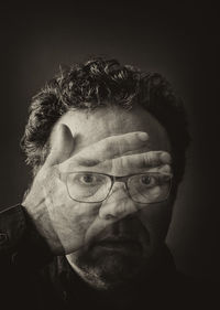 Double exposition photo. man closed his face with hand. schizophrenia or bipolar disorder concept