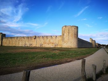 View of fort on field against cloudy sky