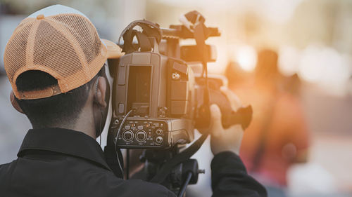 Rear view of man photographing