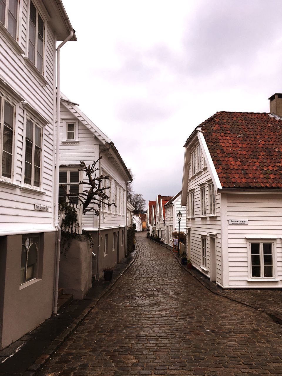 STREET AMIDST BUILDINGS AGAINST SKY