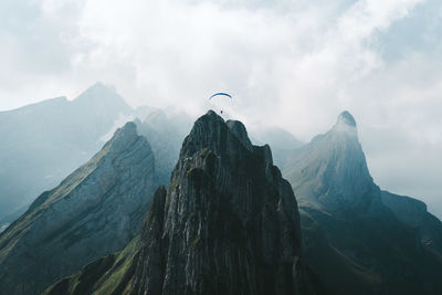 Scenic view of mountains against cloudy sky