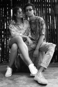 Portrait of young couple sitting on seat