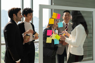 Cheerful business people having discussion at office