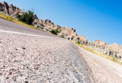 Surface level of road against clear sky