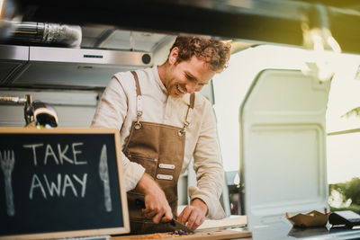 Side view of young man working in office