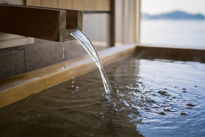 Close-up of water falling in bathtub