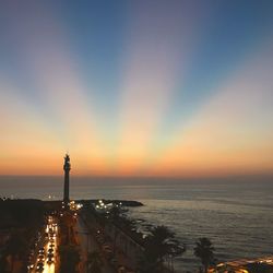 View of city at waterfront during sunset