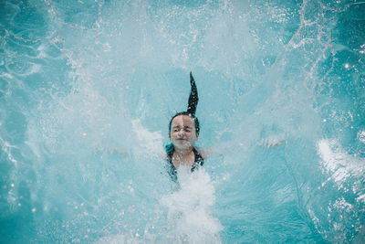 High angle view of girl swimming in pool