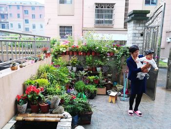 Women standing by flowers