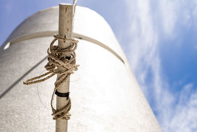 Low angle view of cross against sky