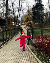 Full length of boy standing on footpath