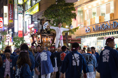 People on street in city at night